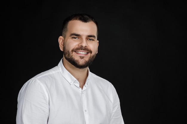 Closeup portrait of smiling handsome bearded man looking