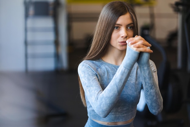 Closeup portrait of a sporty girl during lunges exercise in sportswear