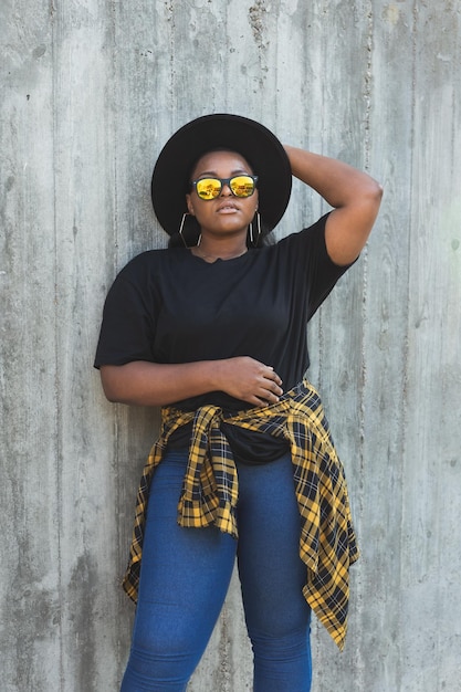 Closeup portrait stylish young African American girl with curly hair in fashionable sunglasses in urban with copy space and place for advertising summer hipster photos with instagram style