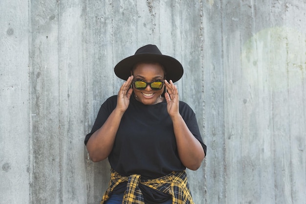 Closeup portrait of stylish young african american girl with curly hair in fashionable sunglasses in