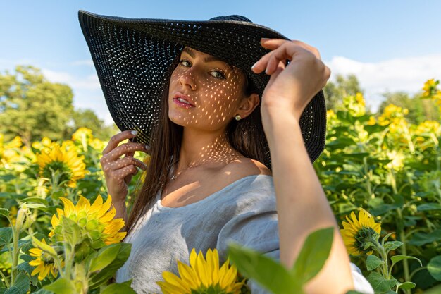 Closeup portrait of woman in elegant hat enjoying summer sun pattern of shadows falling on her face