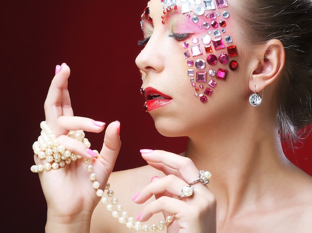 Closeup portrait of woman with artistic make up. 