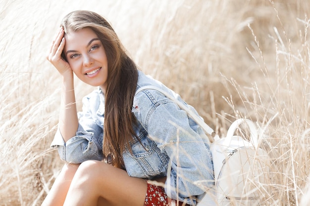 Closeup portrait of young beautiful woman outdoors. Attractive female on neutral background.