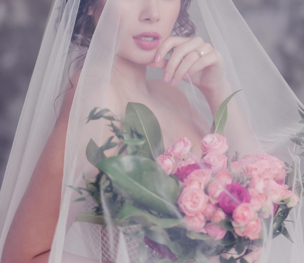 Closeup portrait of young gorgeous bride with veil