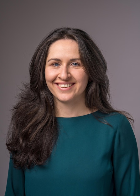 closeup portrait of a young happy woman looking at the camera and smiling cheerfully