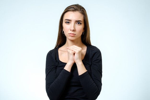 Closeup portrait of a young woman praying isolated