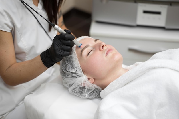 Closeup process of laser removal of blood vessels from the skin