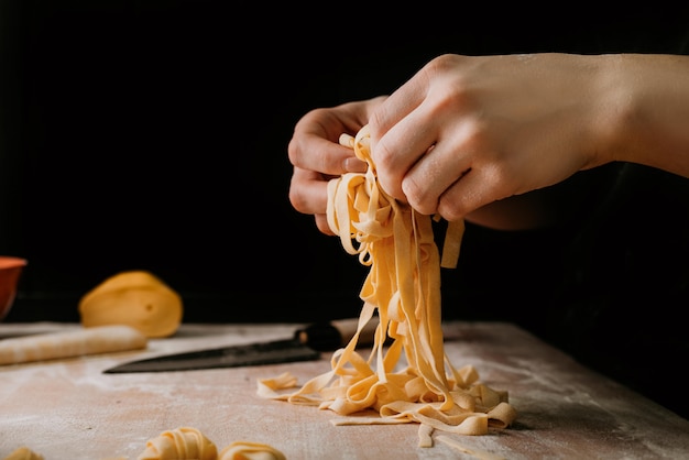 Closeup of process of making cooking homemade pasta. 