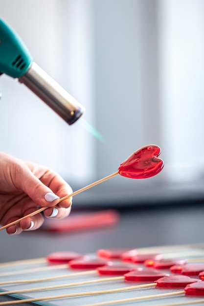 Closeup the process of making heartshaped lollipops