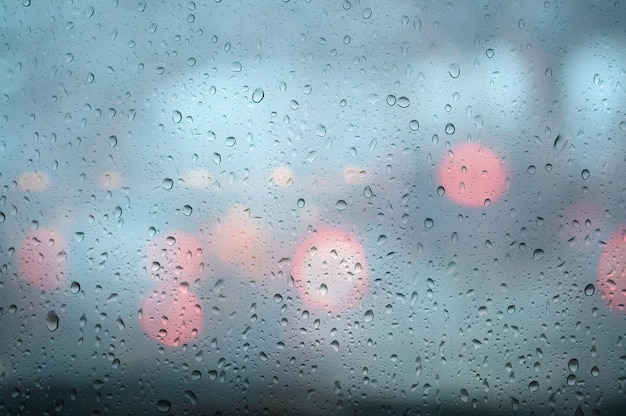 Closeup Rain drops on window glass background.