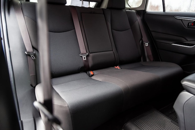 Photo closeup on rear seats with velours fabric upholstery in the interior of an old korean car in gray after dry cleaning auto service industry