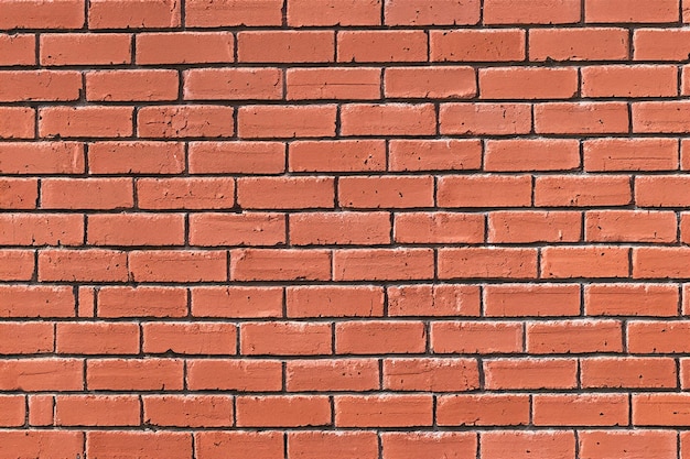 Photo closeup of a red brick wall with a standard brick pattern