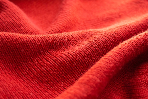 Closeup red knitted woolen fabric texture background