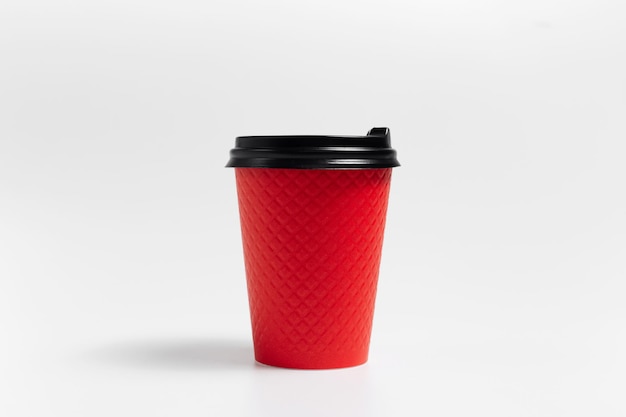 Closeup of red paper cup of coffee takeaway on white background