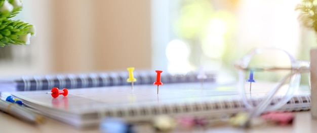 Closeup a red pin on blank desk calendar