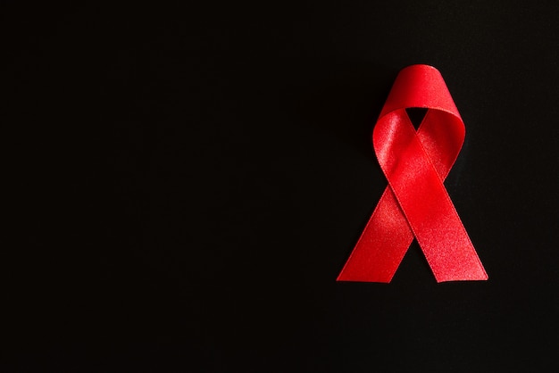 Closeup red ribbon awareness on black background  for World Aids day campaign