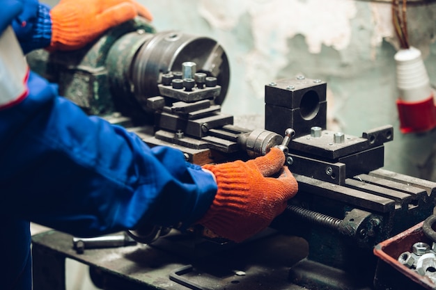 Closeup of repairman in uniform, professional builder working using construction equipment. Process of building, apartment renovation, repairing, building. Sawing, connecting, cutting, preparing.