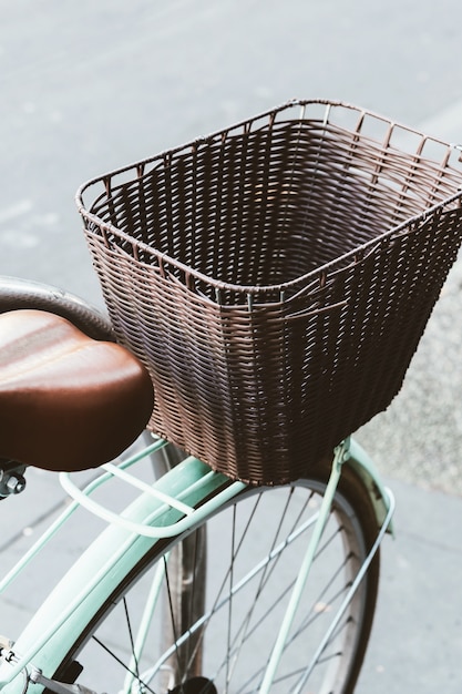 Closeup of a retro blue bicycle's basket.