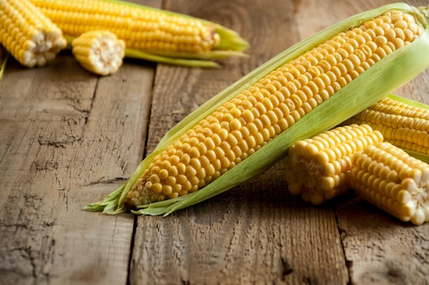 Closeup Ripe Fresh Corn on Wooden Table.