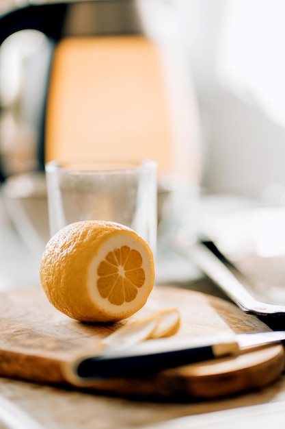 Closeup of a ripe yellow sliced lemon on a Board in the kitchen. Food and fruit concepts