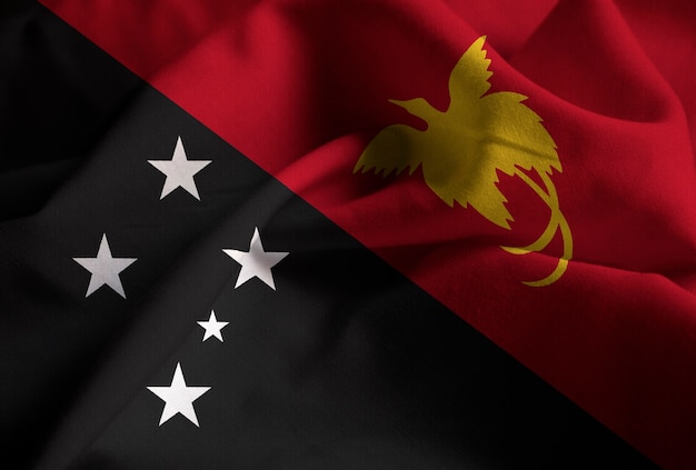 Closeup of Ruffled Papua New Guinea Flag, Papua New Guinea Flag Blowing in Wind