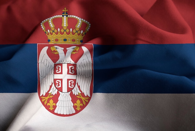 Photo closeup of ruffled serbia flag, serbia flag blowing in wind