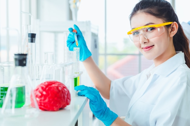 Closeup Science women students working with chemicals in lab