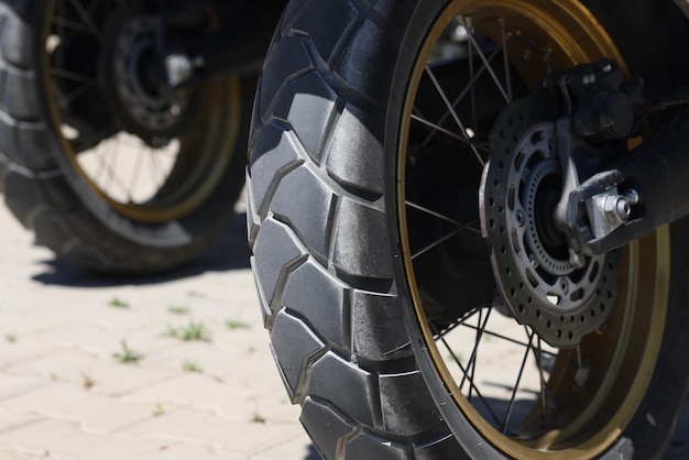 Closeup of scooter wheel in parking lot