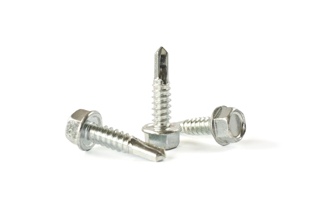 Closeup Self Drilling screws for roofing with a drill isolated on white. Isolated fasteners. 