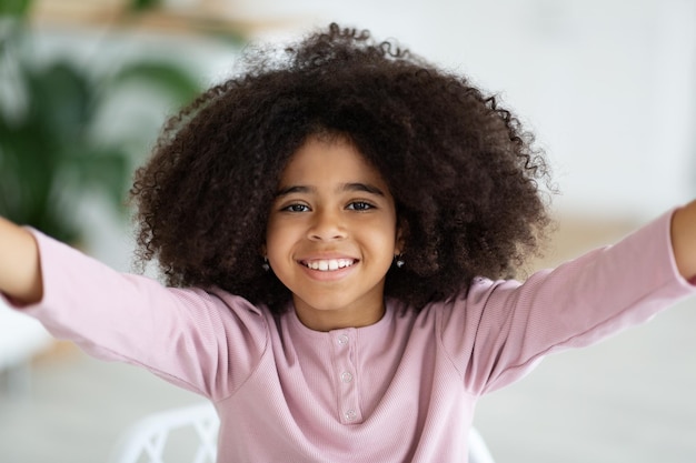 Closeup shot of adorable african american girl taking selfie