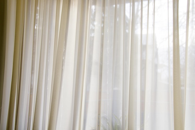 Closeup shot of a beautiful limpid beige curtain - interior