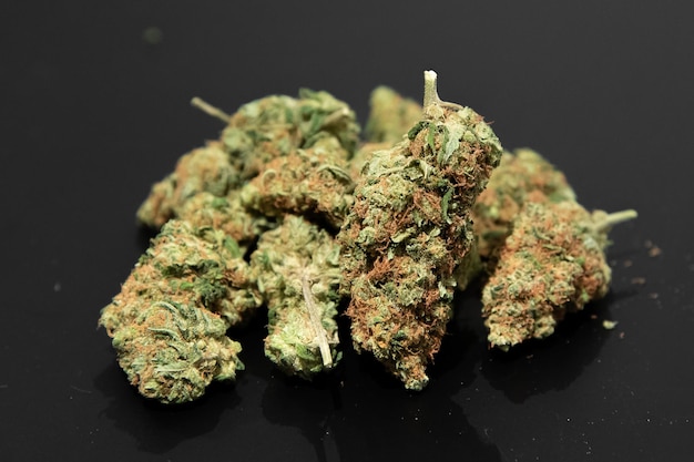 Closeup shot of cannabis buds on the table