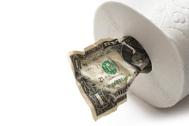 Closeup shot of crumpled one dollar bill put inside a toilet paper roll Concept of essentials shortage during covid19 pandemic