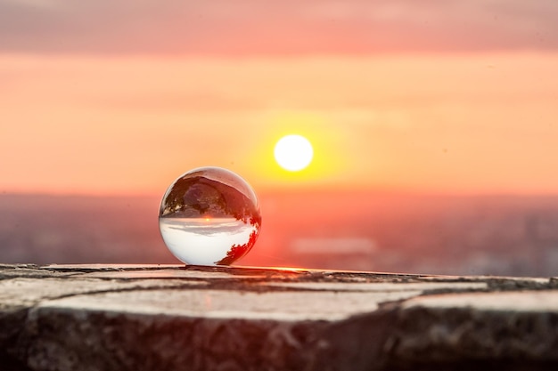 Closeup shot of a crystal ball with the scene of the beautiful sunset inside