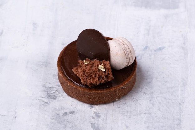 Closeup shot of a delicious chocolate dessert with macaroon