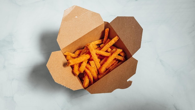 Closeup shot of delicious french fries on a white surface