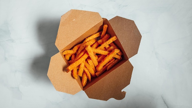 Closeup shot of delicious french fries on a white surface