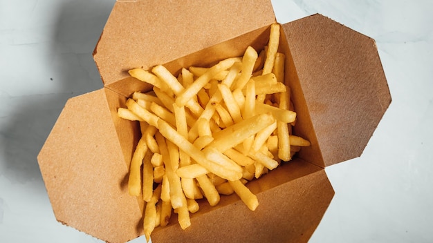 Closeup shot of delicious french fries on a white surface