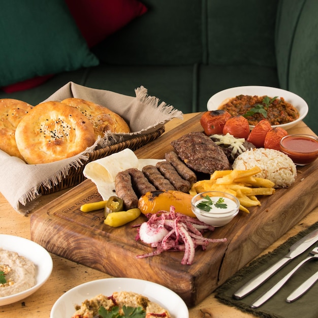 Closeup shot of deliciously prepared kebab served with grilled vegetables rice and garnish