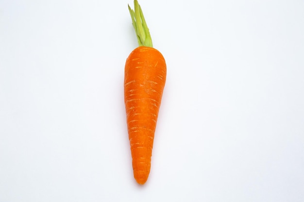 Closeup shot of a fresh carrot in the middle of a white background