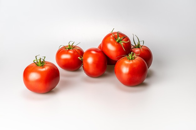 Closeup shot of fresh tomatoes isolated on a white background