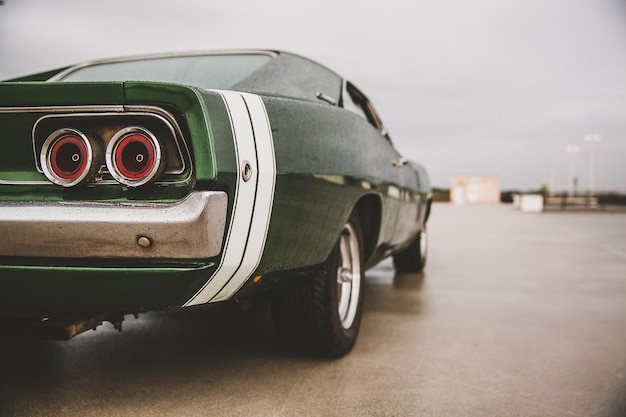 Closeup shot of a green muscle car on a blurred background