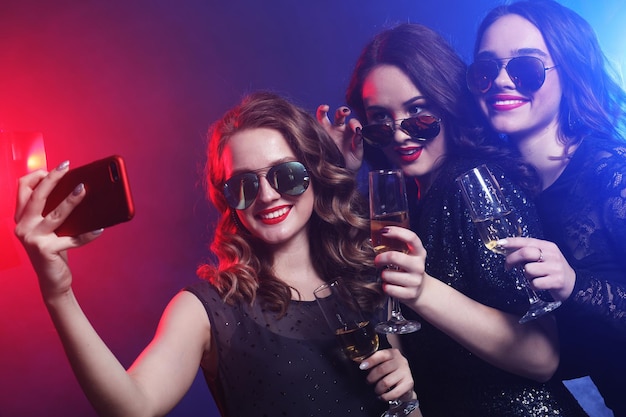 Closeup shot of group of laughing girls having party take self