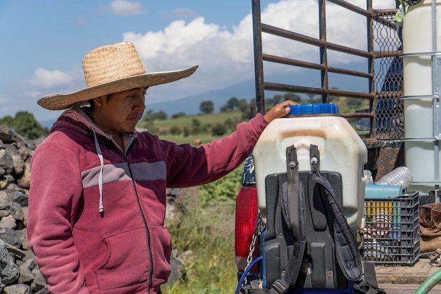 Closeup shot of a guy with equipment for watering the fields