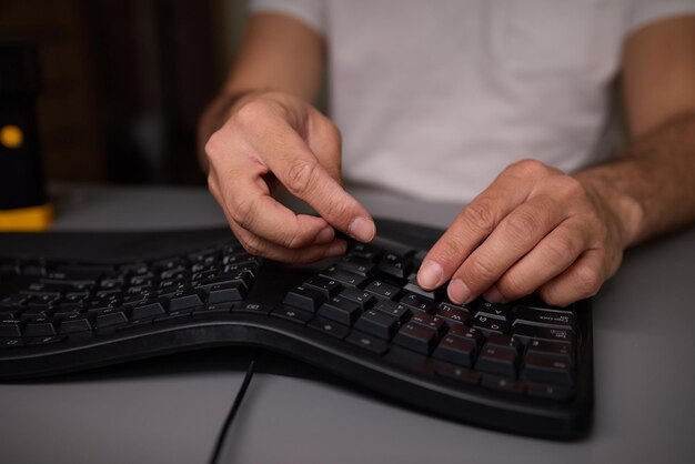 Photo in a closeup shot a hand is seen using a keycap puller tool to meticulously remove a keyboard key