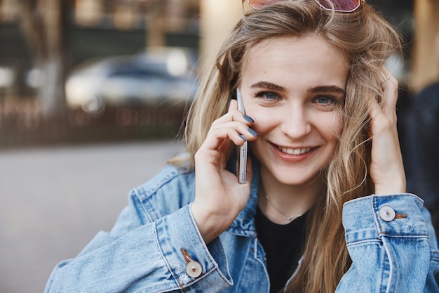 Closeup shot of happy Caucasian girlfriend in denim jacket over