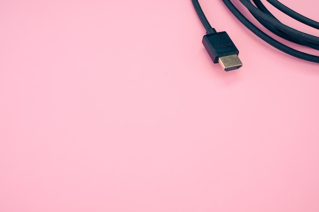 Closeup shot of HDMI cable isolated on a pink background