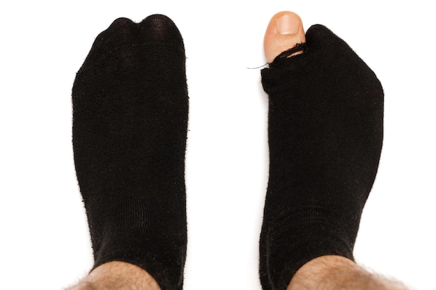 Closeup shot of male feet in hoaly socks with sticking out toe