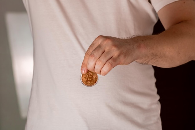 Closeup shot of a male holding a bitcoin bitcoin cryptocurrencies concept