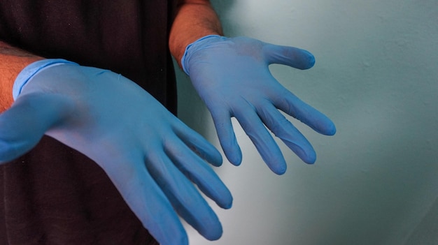 Closeup shot of a male wearing disposable gloves